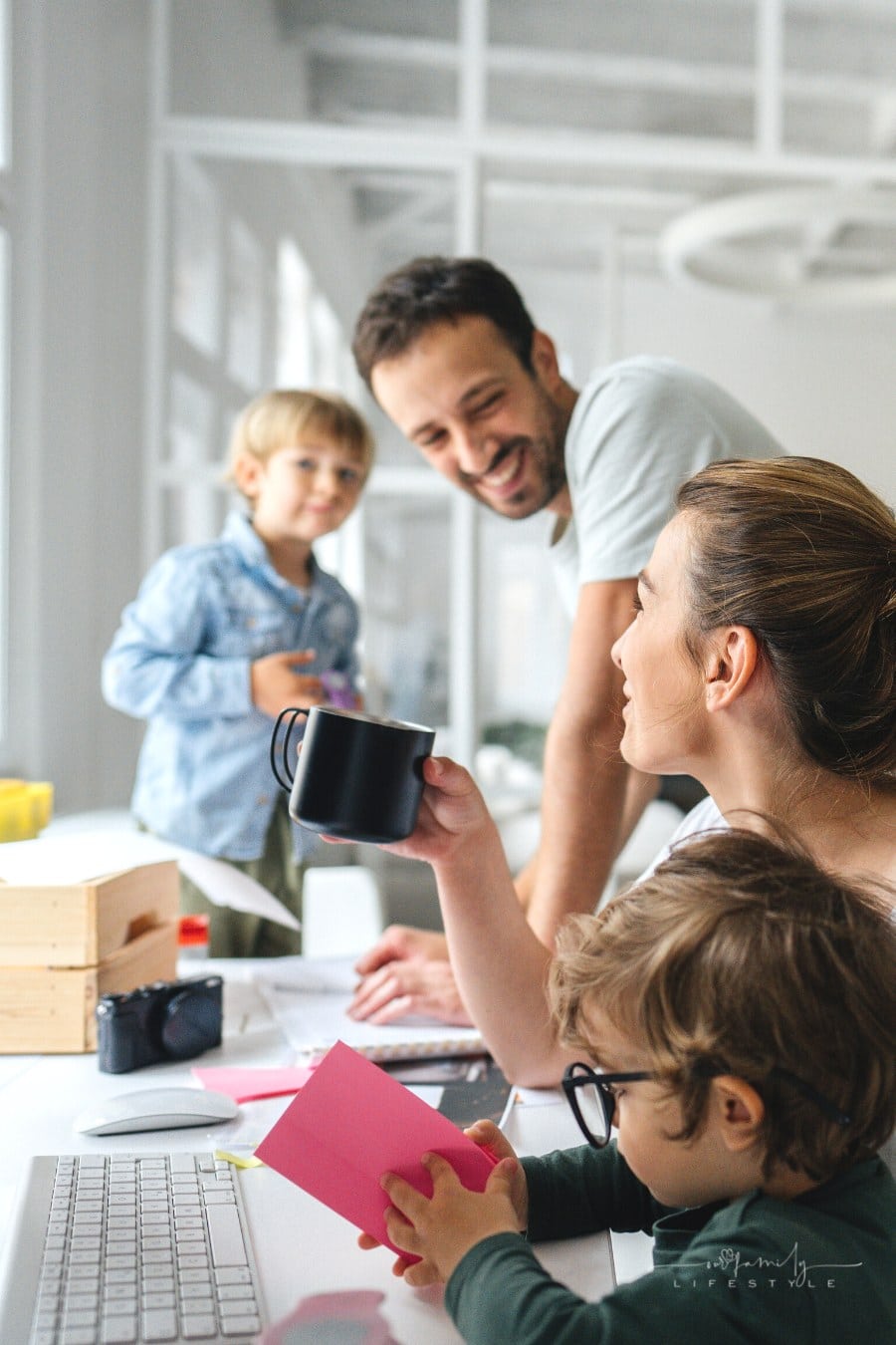 parents working in home-based office with their two young sons