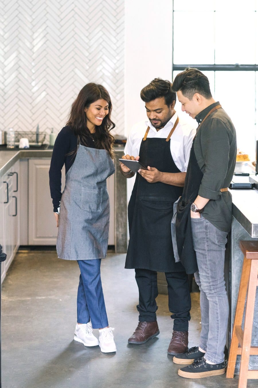 family business owners discussing running a cafe POS system