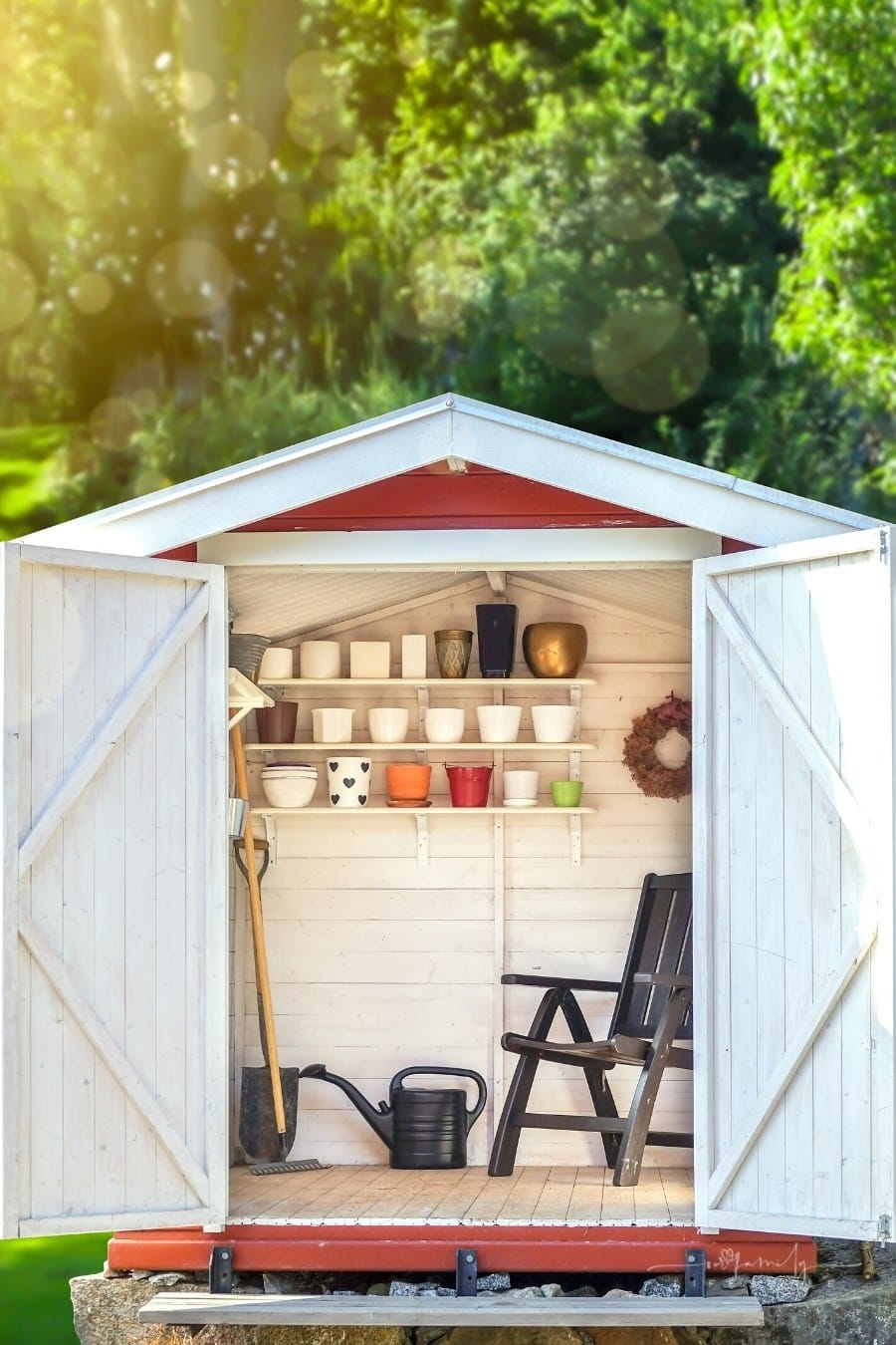 garden shed with open doors filled with gardening tools