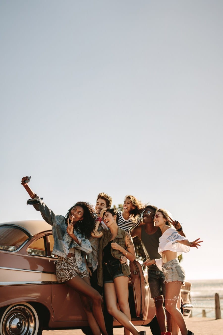 Multi Ethnic Friends Taking a Selfie near a Car during road trip