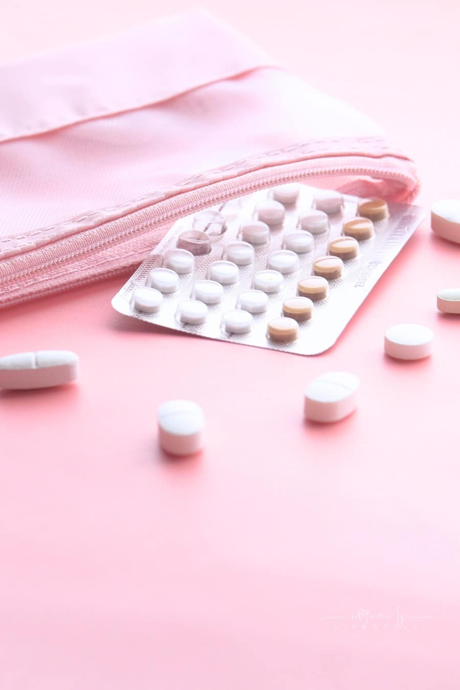 Birth Control Pills on Pink Background with Copy Space