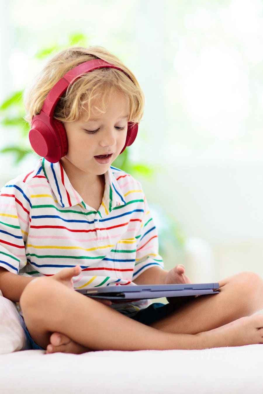 Child with tablet computer. Kids study online.