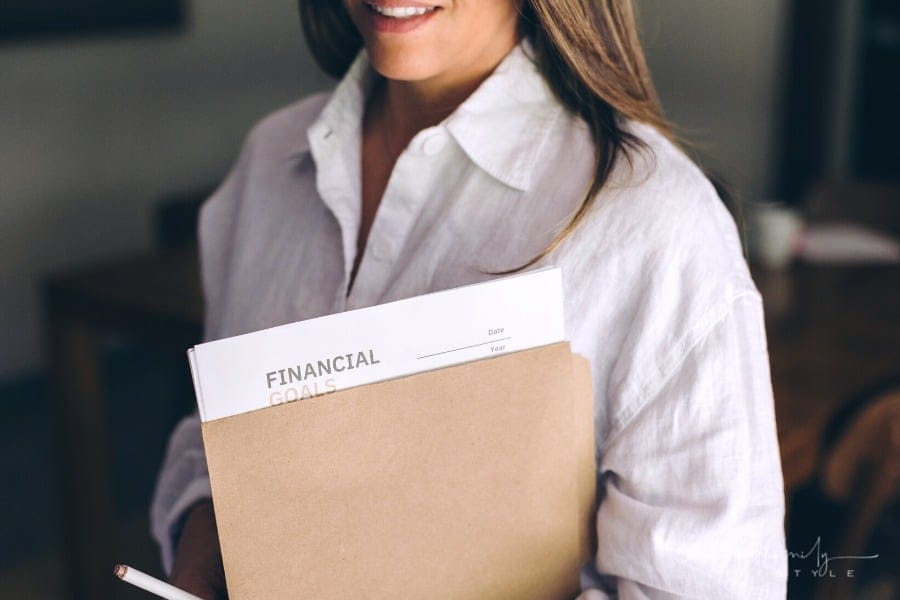woman holding folder with financial goals for family budget planning