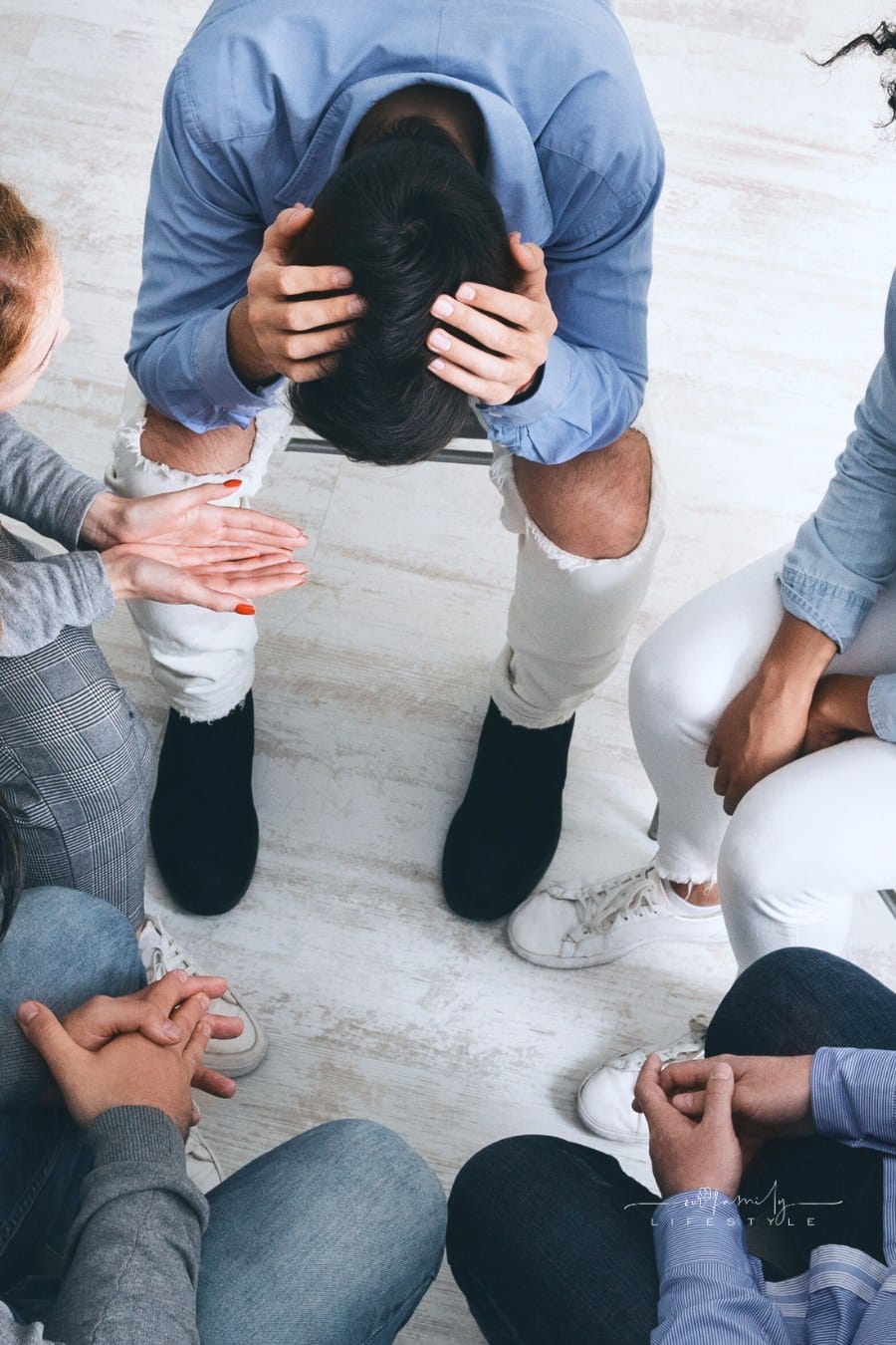 Depressed man suffering from lots of problems at support group meeting
