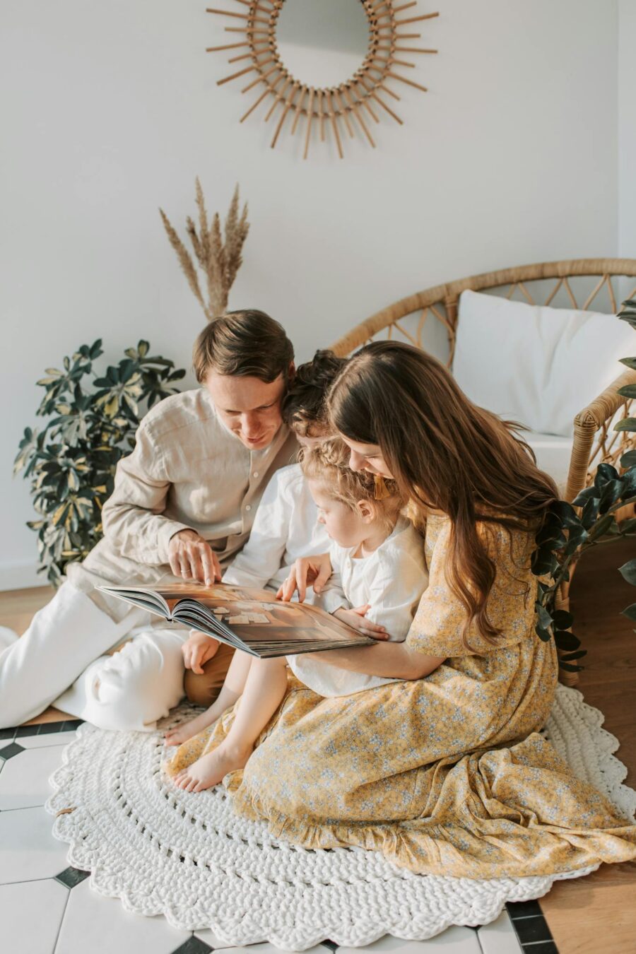 A family enjoying quality time reading together in a cozy living room setting.