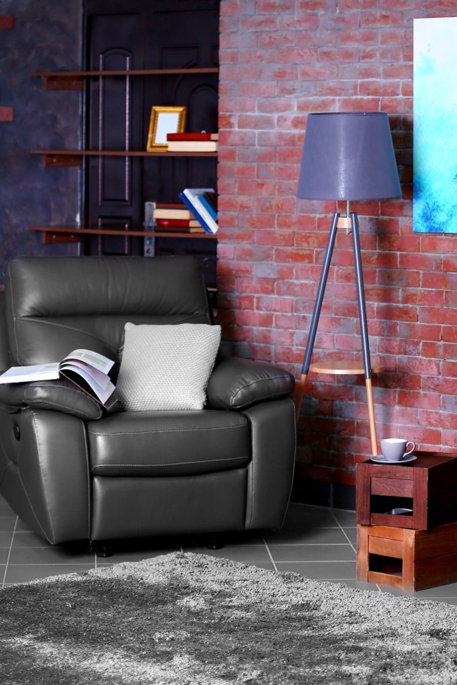 comfy chairs and makeshift table in front of red brick wall