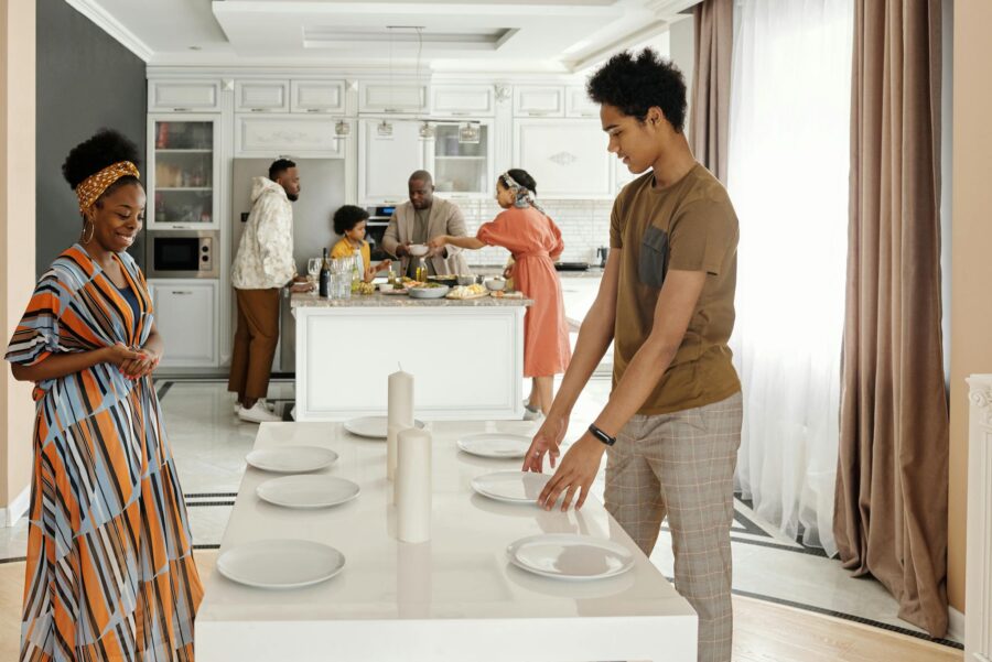 A joyful family gathers to prepare a meal in a bright, modern kitchen setting, celebrating togetherness.