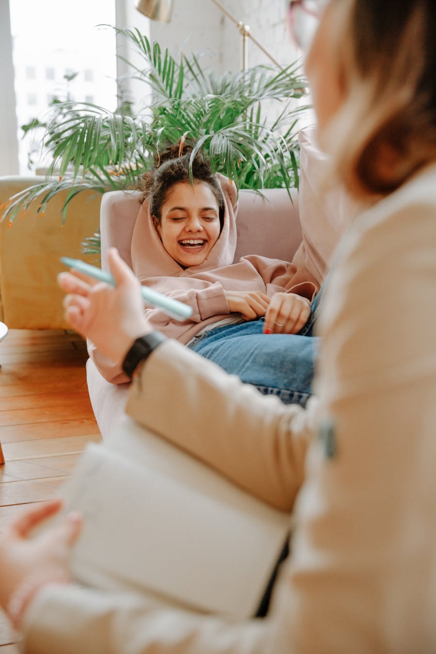 A joyful young adult during a casual therapy session indoors.