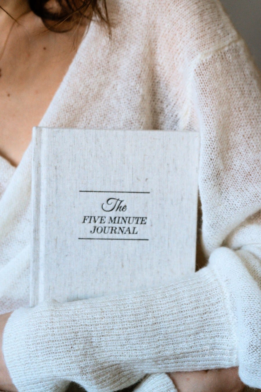 A Person Wearing White Cardigan Holding a Gratitude Journal