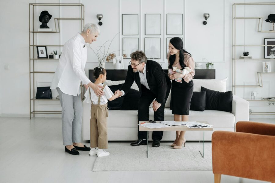 A welcoming family scene involving adults and children indoors, showcasing connection and warmth.