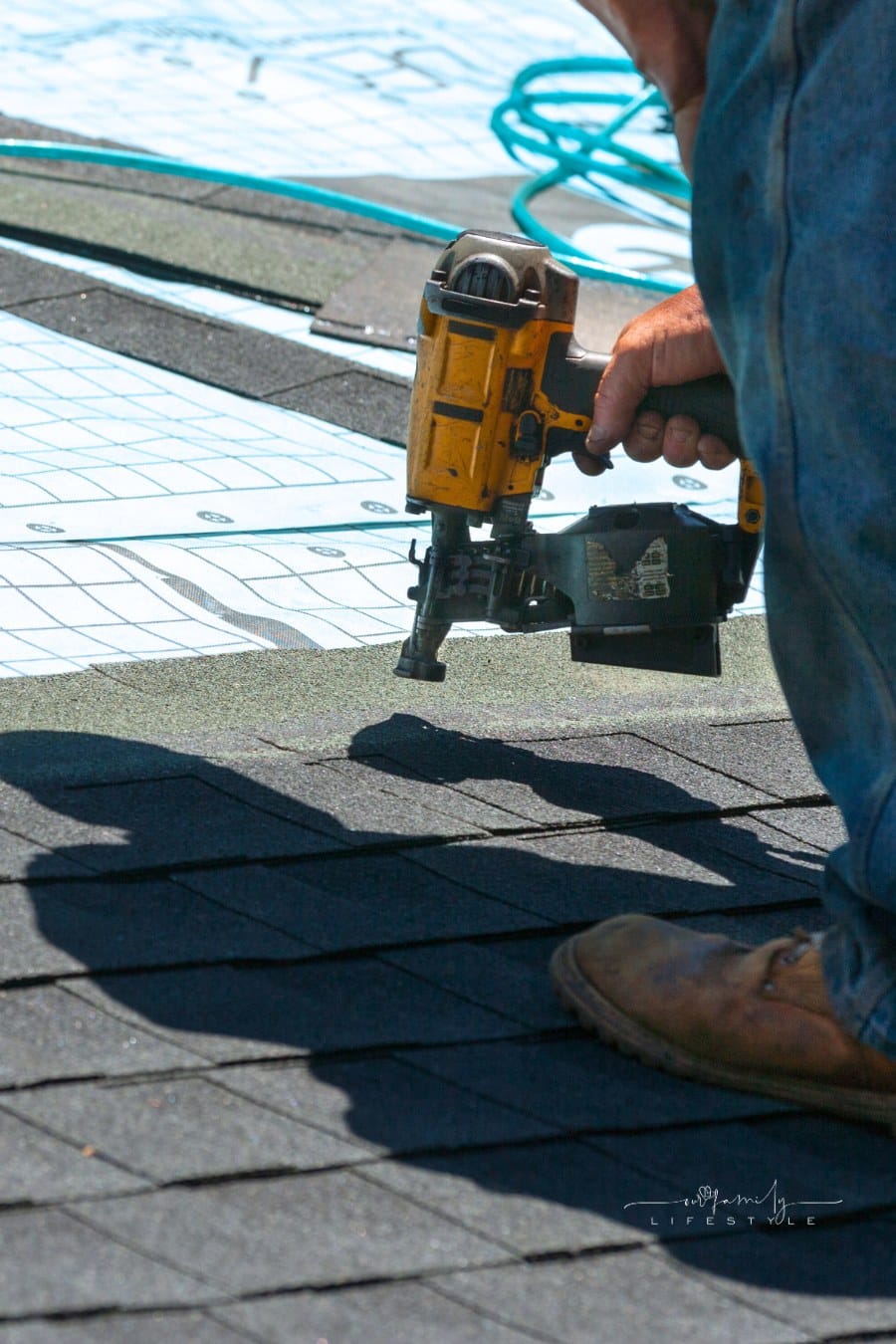Man Using Air Nailer for Roof shingle replacement