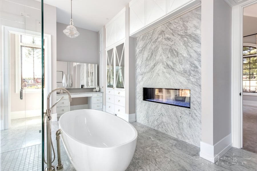 luxury bathroom with freestanding bathtub and fireplace