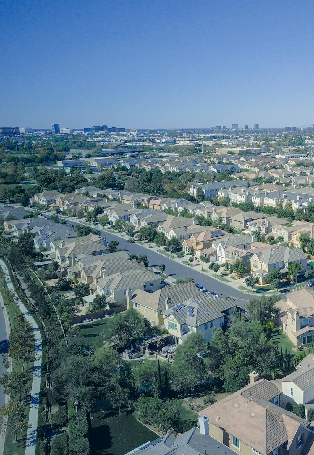 Aerial view of suburban homes in California with solar panels, showcasing sustainable living.