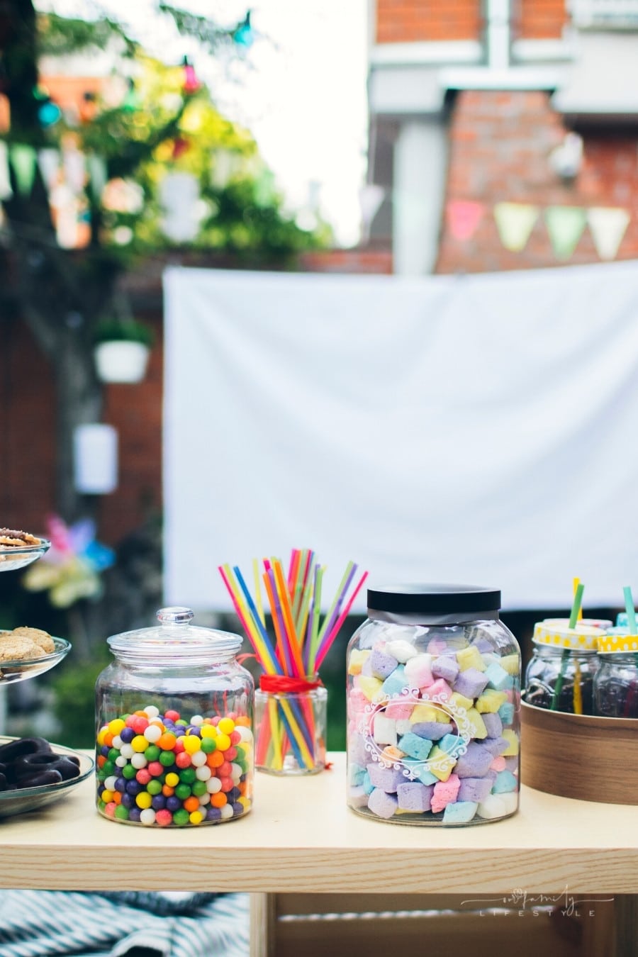 snacks and drinks set up in front of backyard movie screen