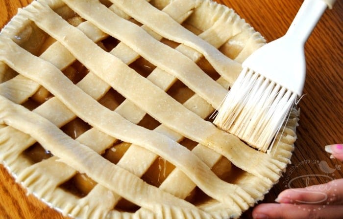 buttering apple pie crust