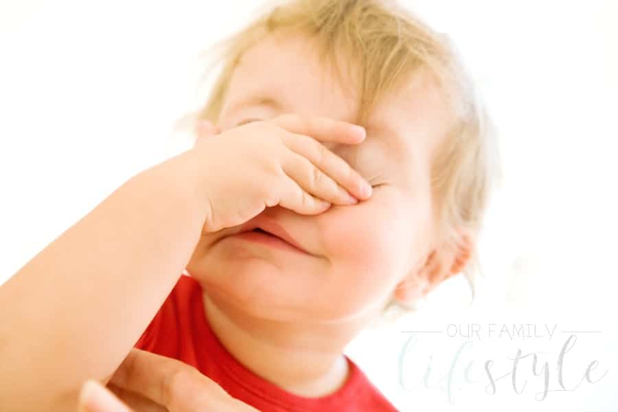 baby playing peekaboo