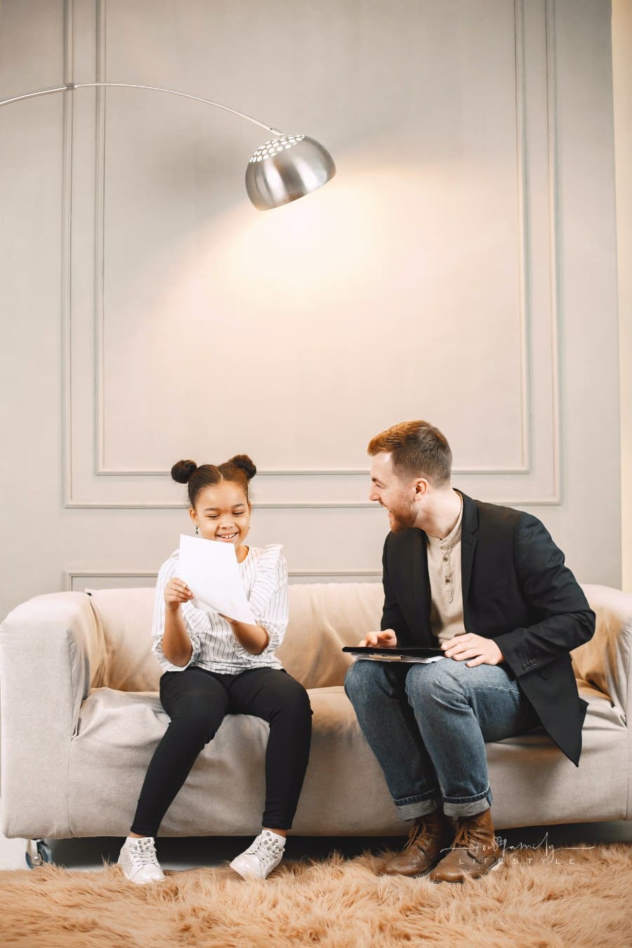 Photo of a Family Therapist Smiling with a Girl