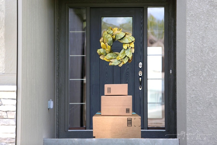 stack of boxes delivered at front door step of house