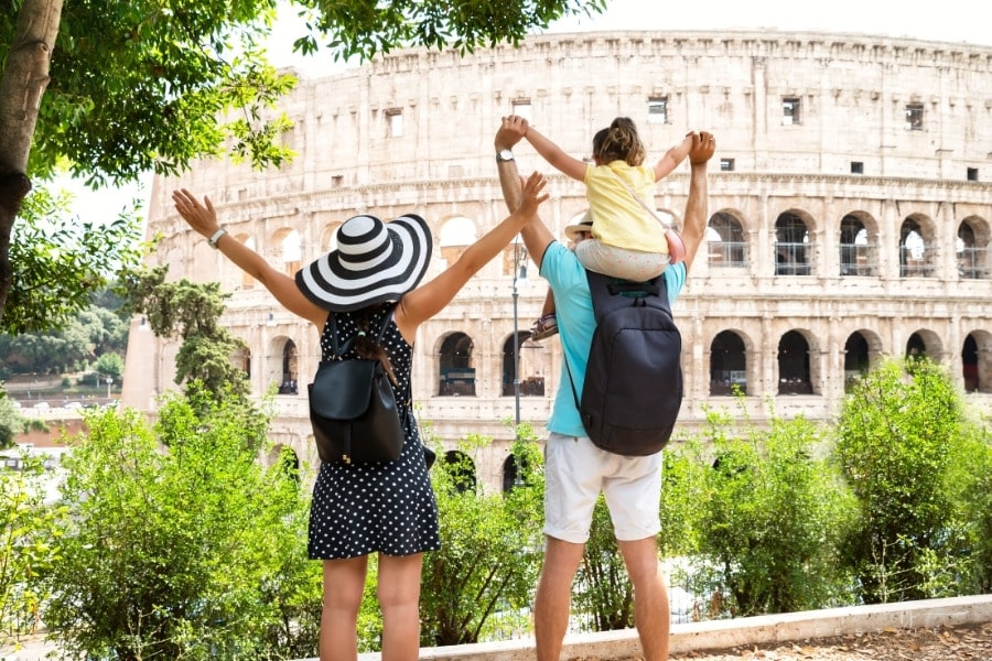young family in front of Colosseum in Rome, Italy