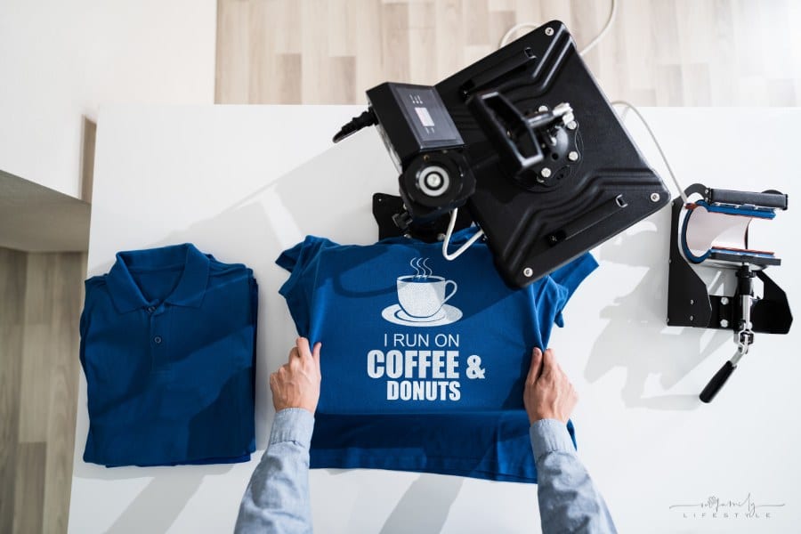 man using heat press for tshirt screen print transfer