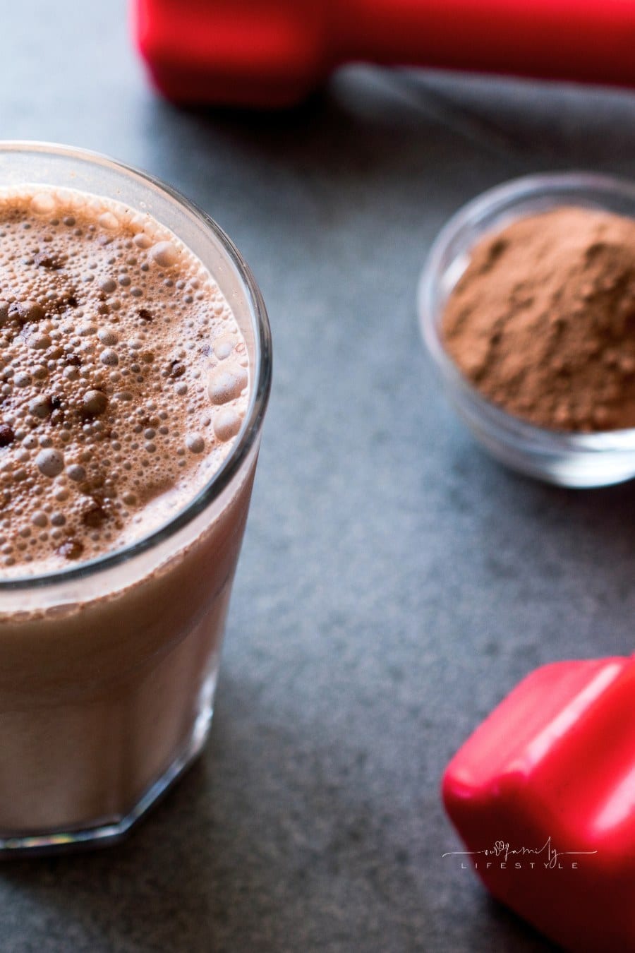 Chocolate Protein Shake Smoothie with Whey Protein Powder and Red Dumbbells