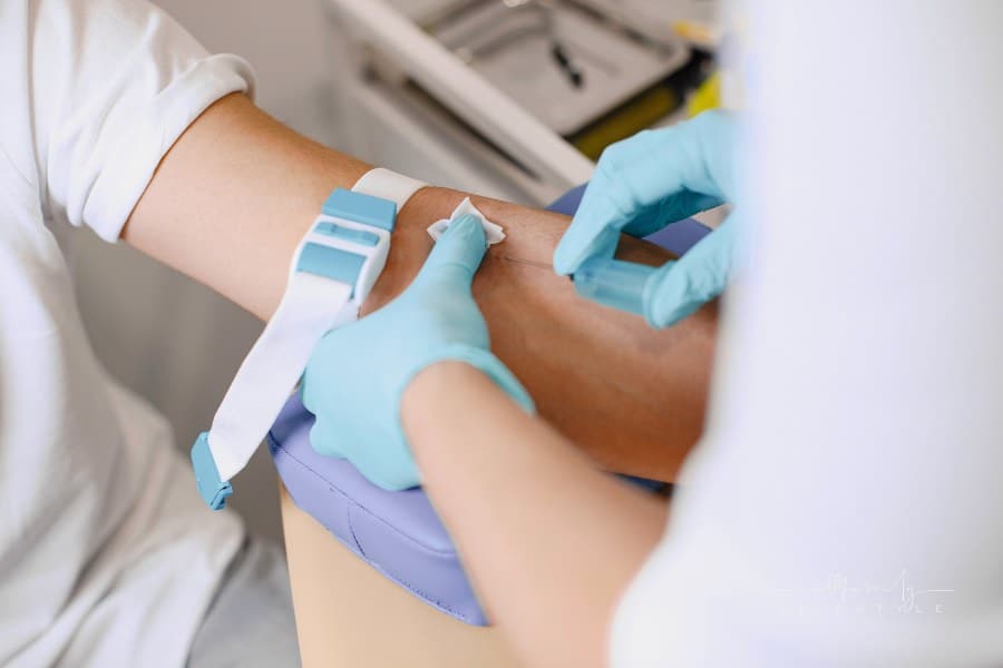 Nurse Taking Blood Sample from Patient's arm