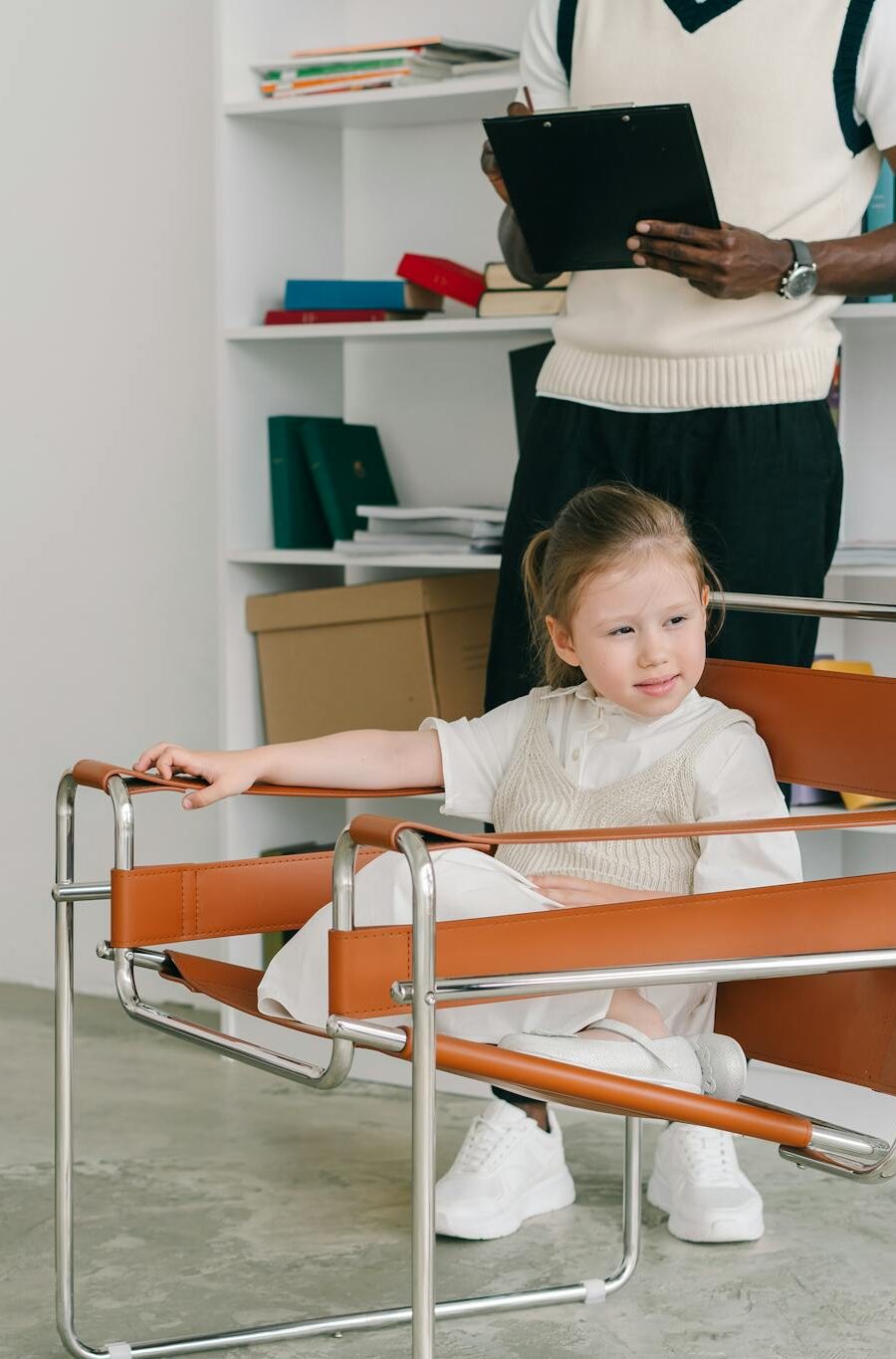 Children engage in a therapy session while the therapist observes with a clipboard.