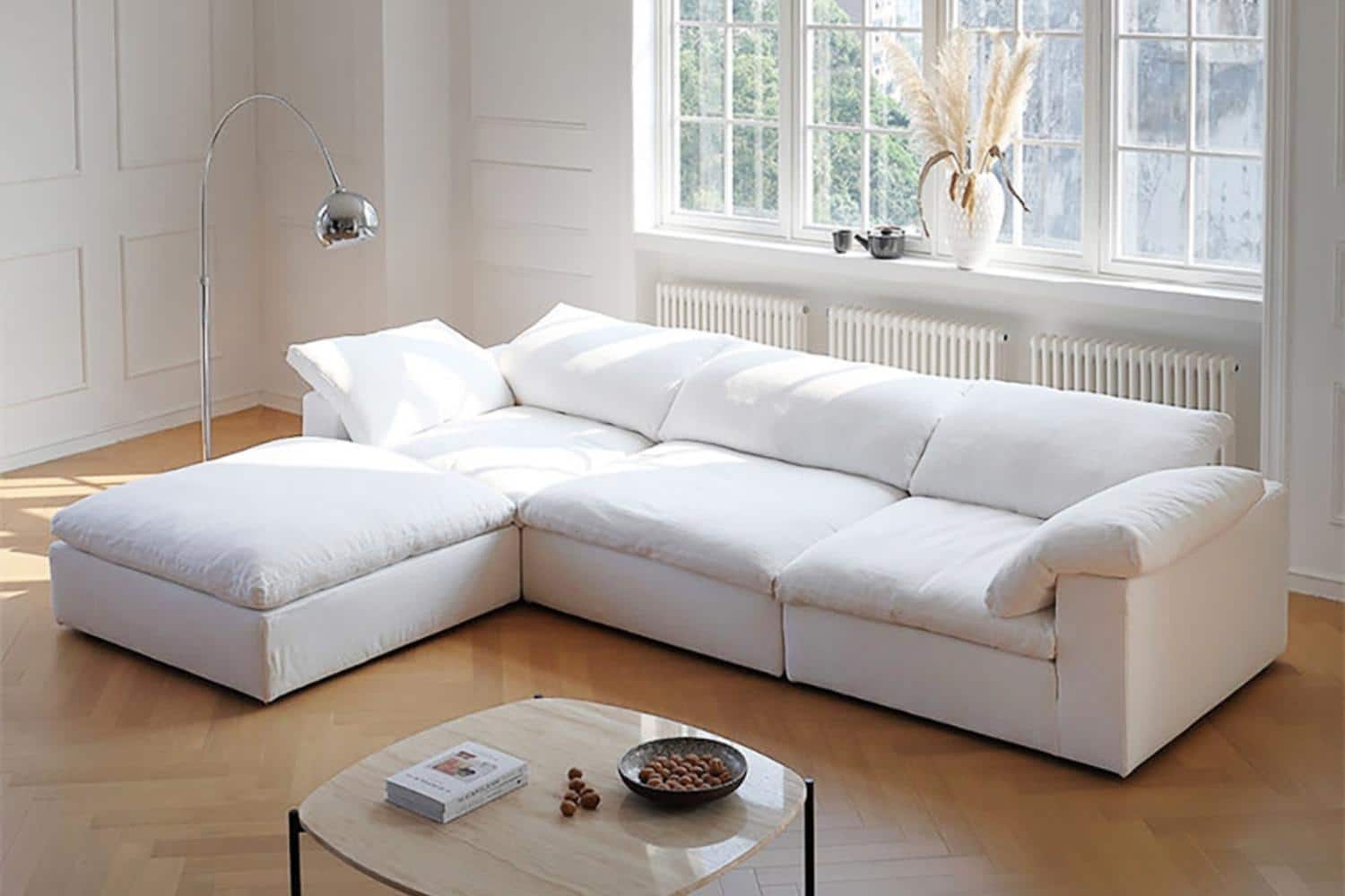 white cloud sofa in front of a large pane window