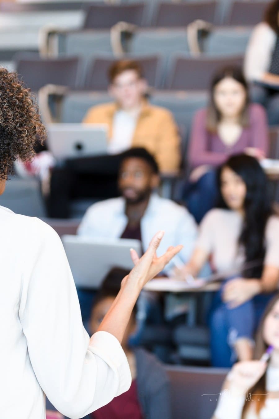 female professor giving lecture to college students