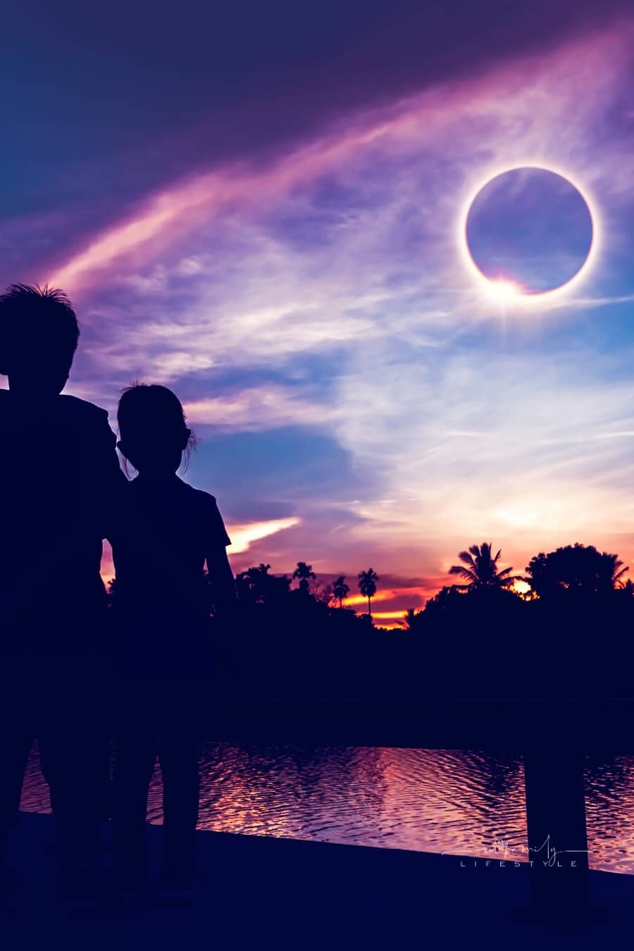 Amazing scientific natural phenomenon. The Moon covering the Sun. Silhouette of mother and children looking at total solar eclipse with diamond ring effect on sky. Happy family spending time together.