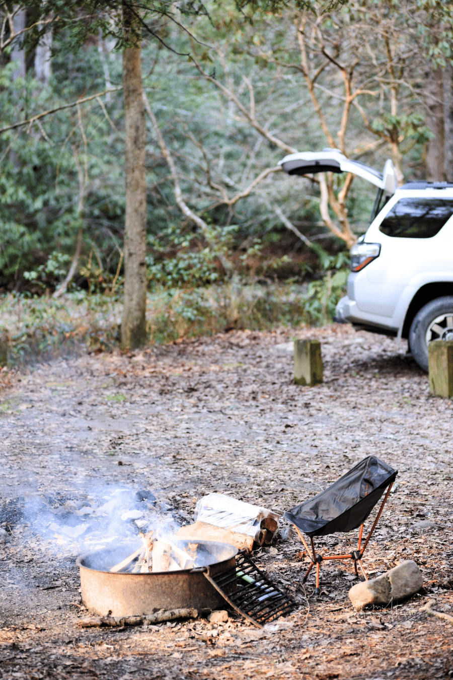 SUV and tent in creek side campsite