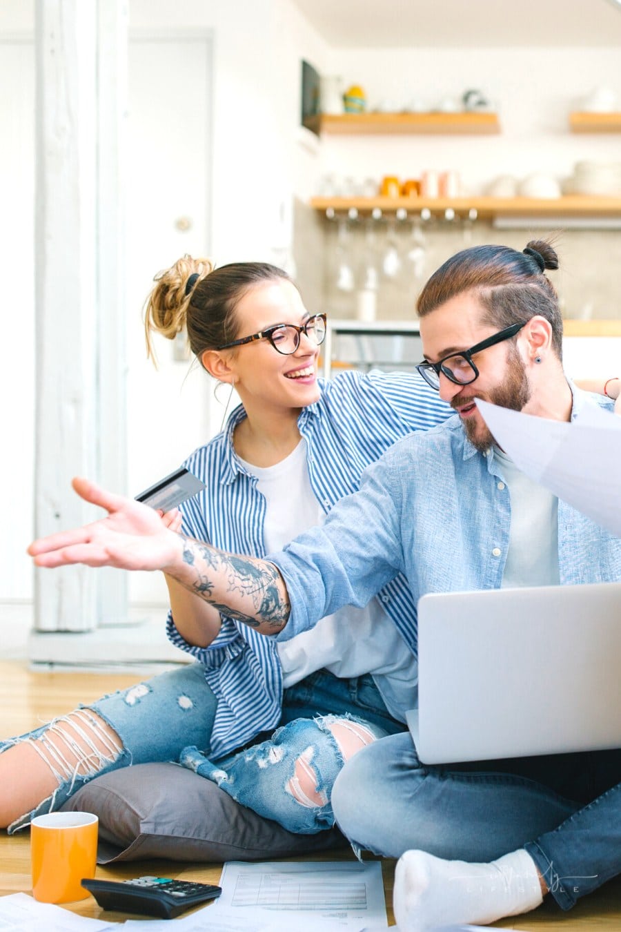 couple working on home budget with credit card in hand