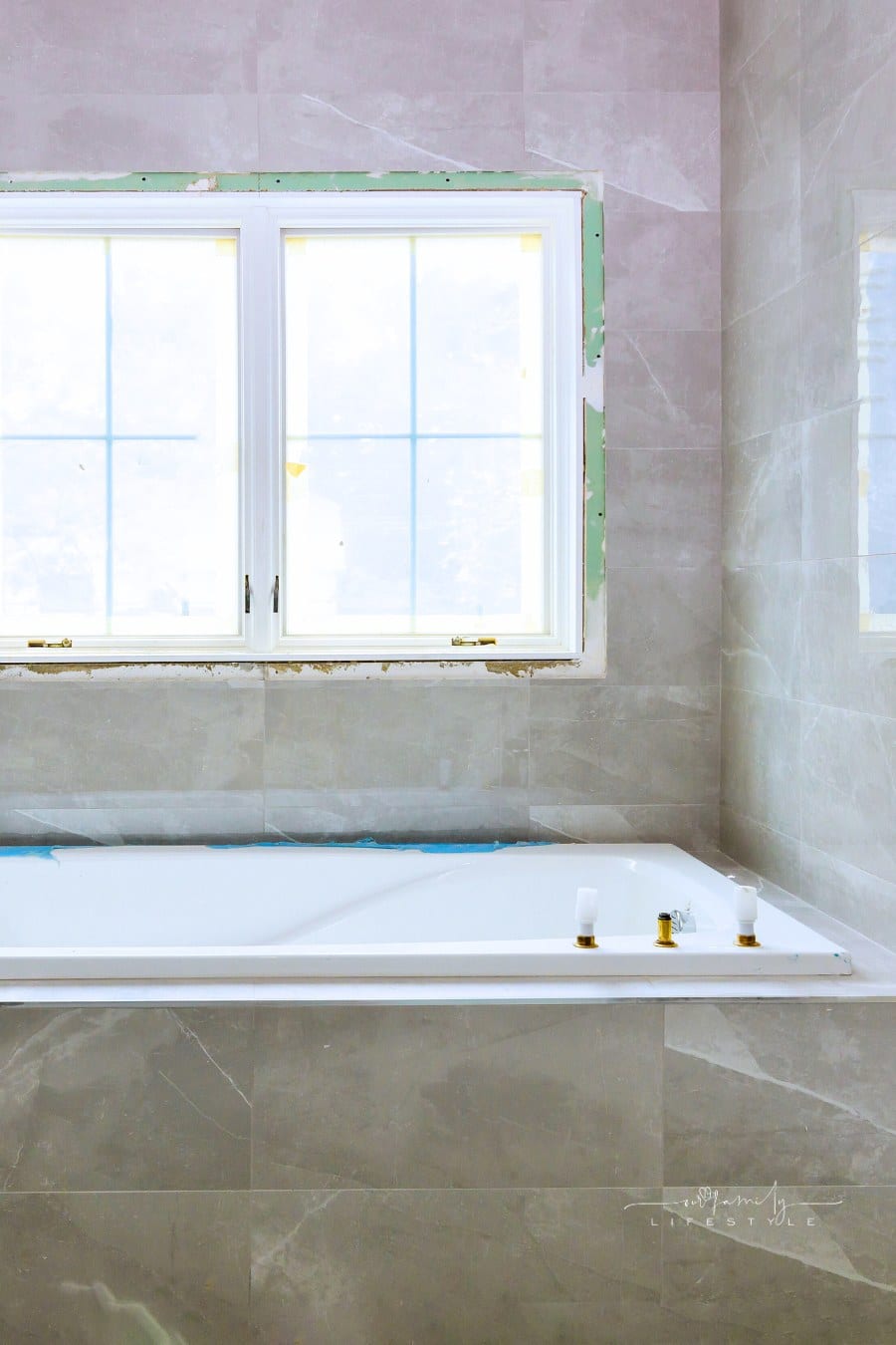 Home construction bathtub tiled walls after installing remodeling master bathroom patching drywall