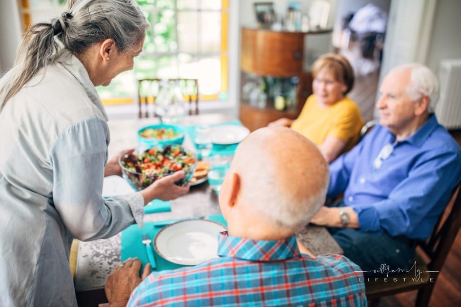 Group of seniors having meal in their retirement home
