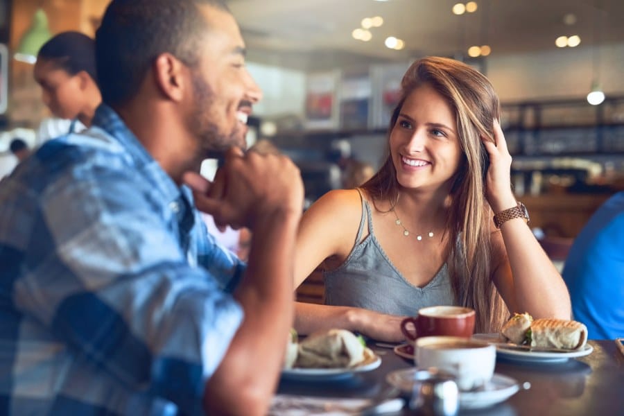 young couple in coffee shop on first date