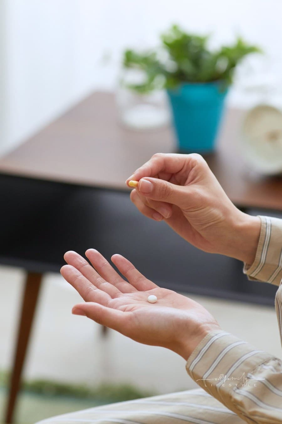 woman holding a white pill in her hand