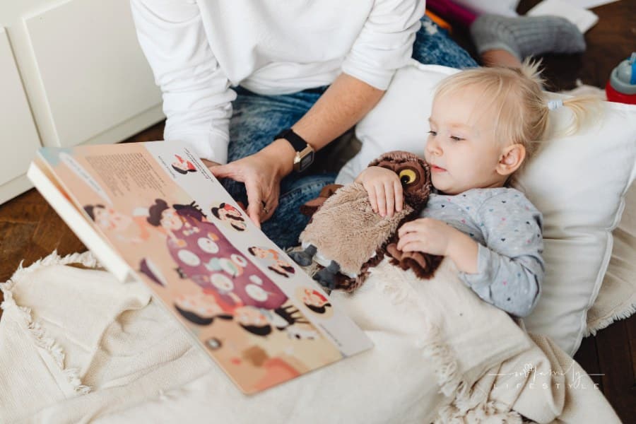 Girl in Bed Listening to Mom read a Fairy Tale