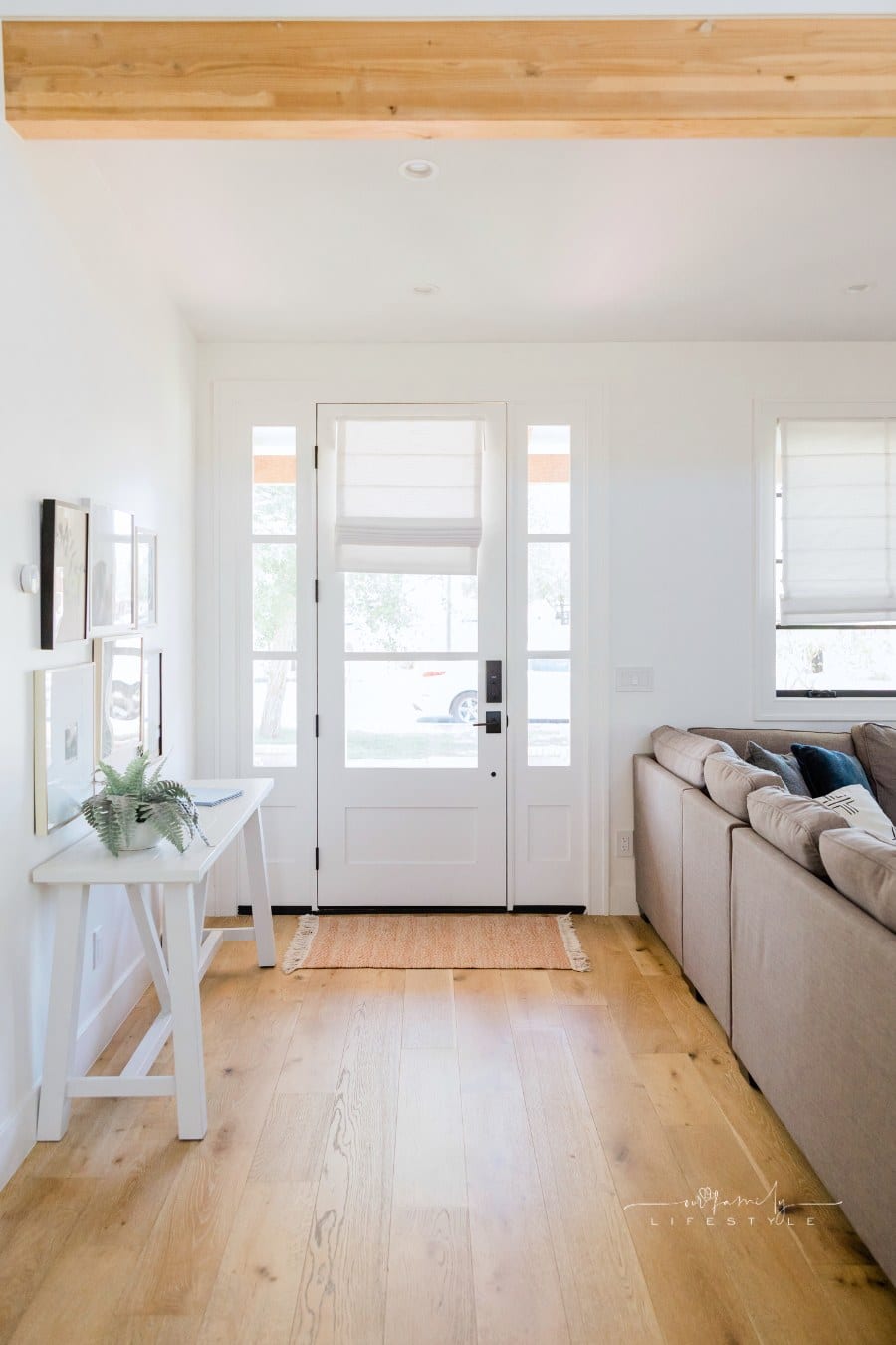 Doorway Interior of a Modern House with Wooden Floors and Matching Ceiling Beam