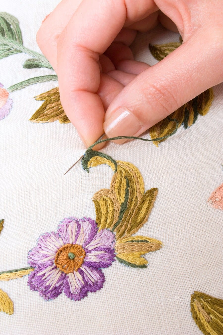 Embroidery needle in woman's hand