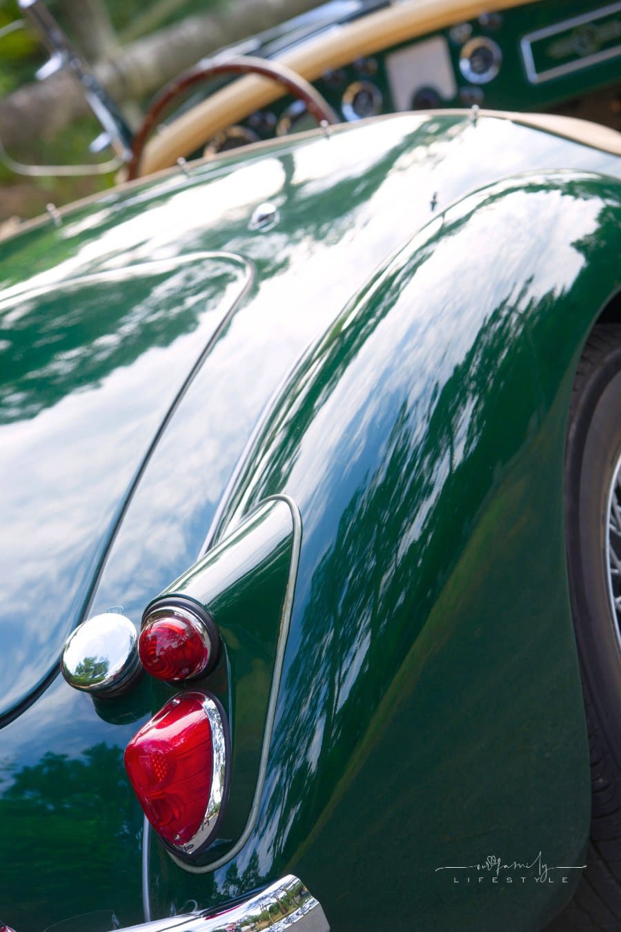 dark green vintage collector car with tan leather interior