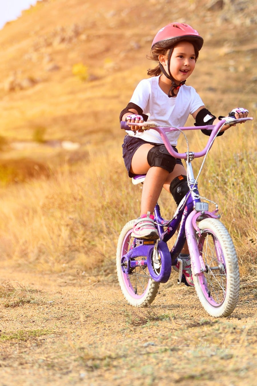 Happy Kid Having Fun in Autumn Park with a Bicycle with full bike gear on