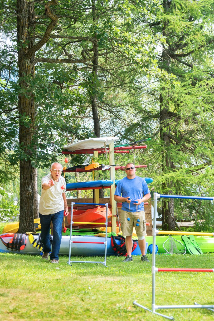 elderly man and adult son playing ladderball game