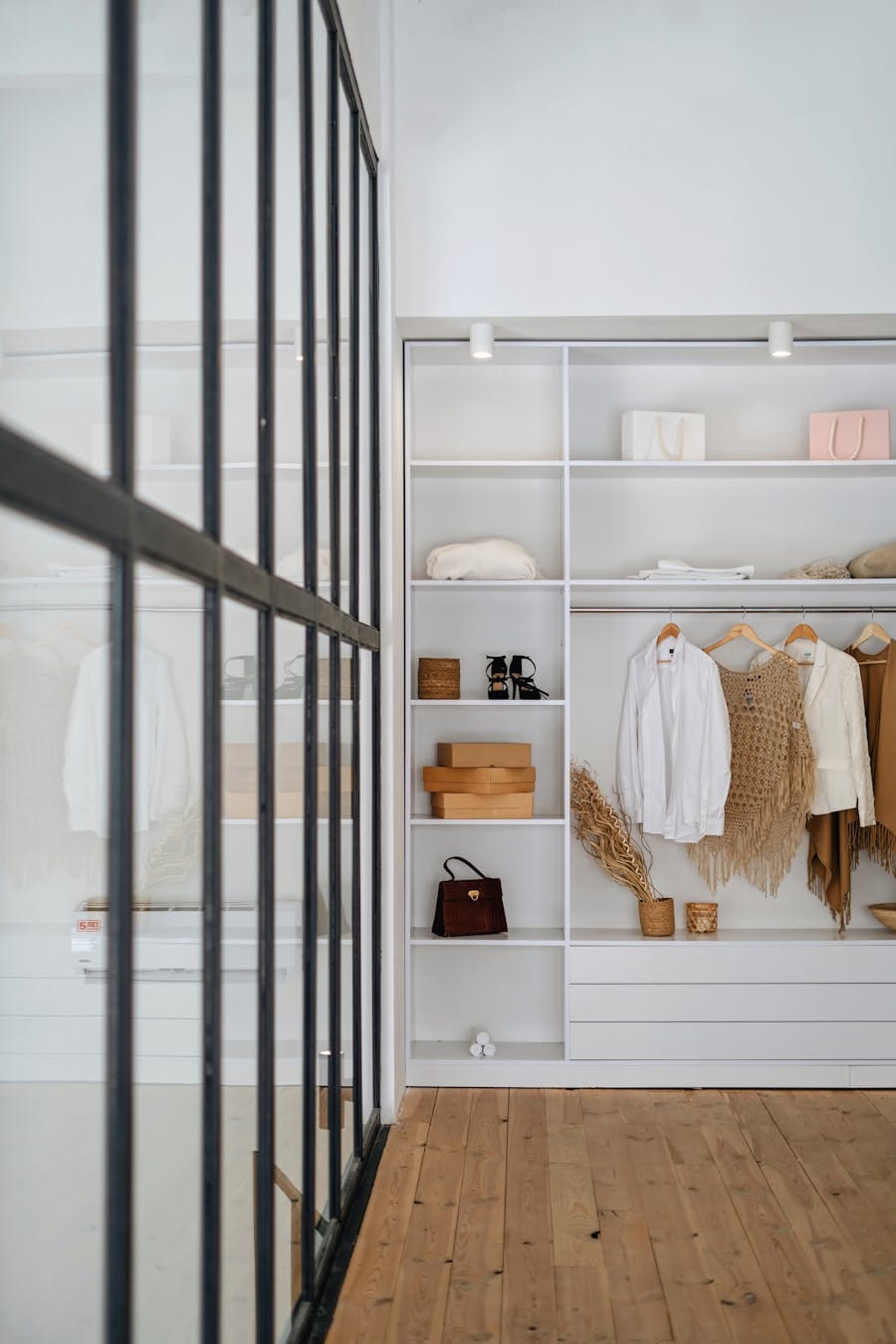 Explore a modern wardrobe setup in a minimalist apartment interior with organized shelves and trendy decor.