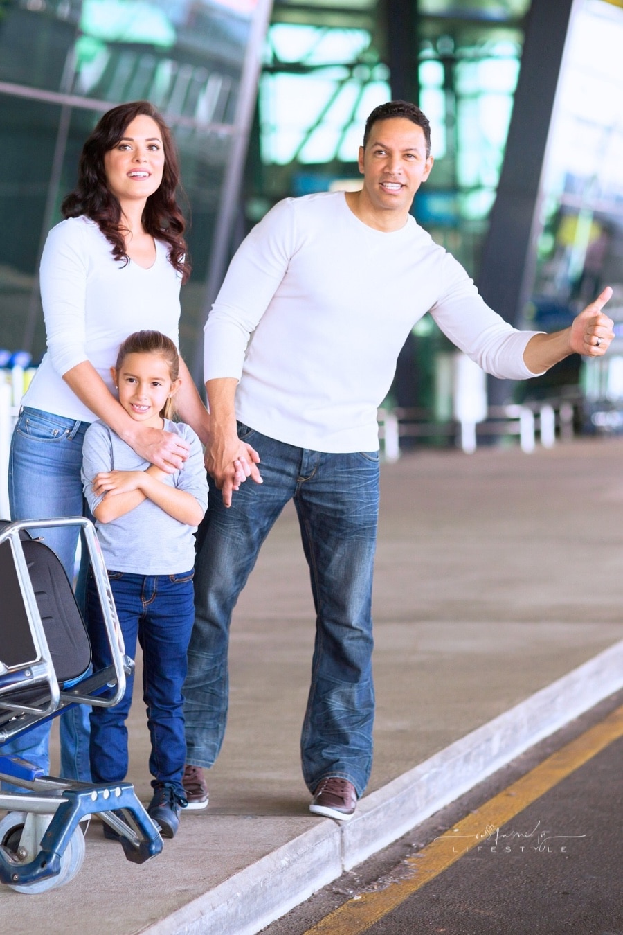 Family hailing a car at the airport