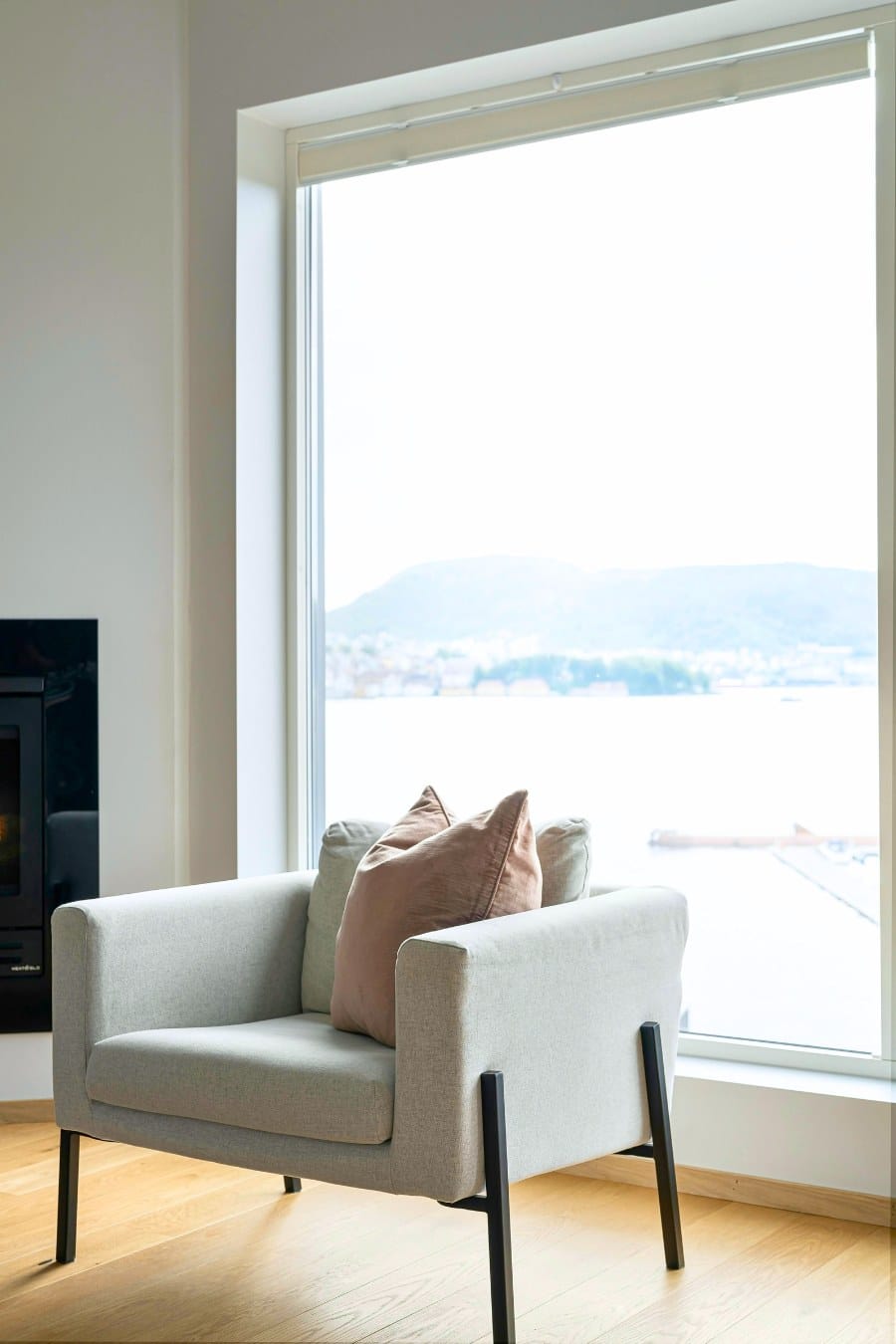 Pillow on Gray Armchair by Large Window
