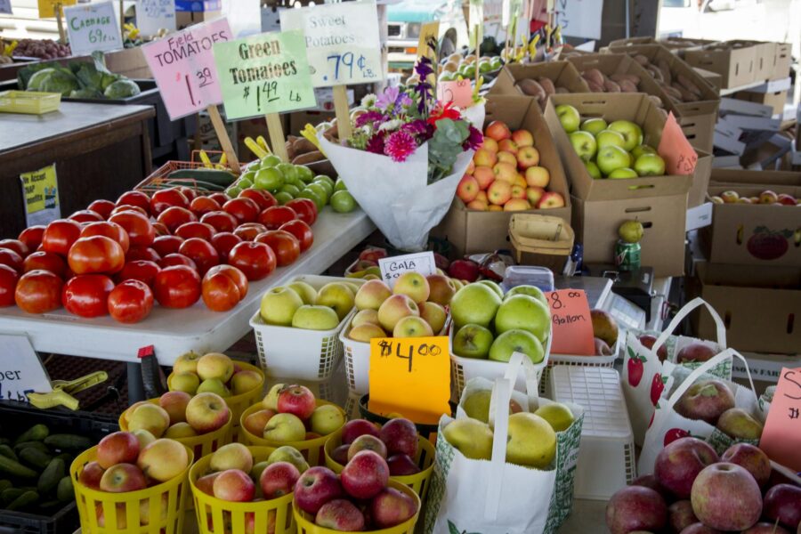 Fresh fruits and vegetables for sale at a North Carolina farmers market stall.