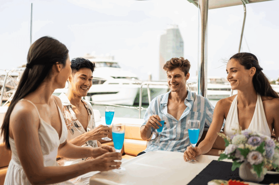 Diverse friends enjoying drinks on a yacht in Palm Beach, highlighting the social side of boating club membership and affordable boat club prices.