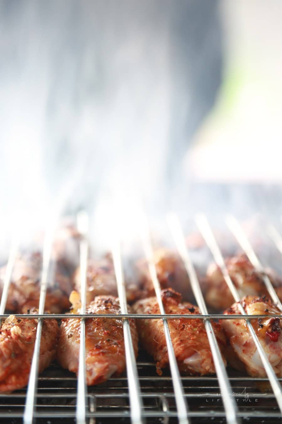 chicken being roasted over an open fire grill