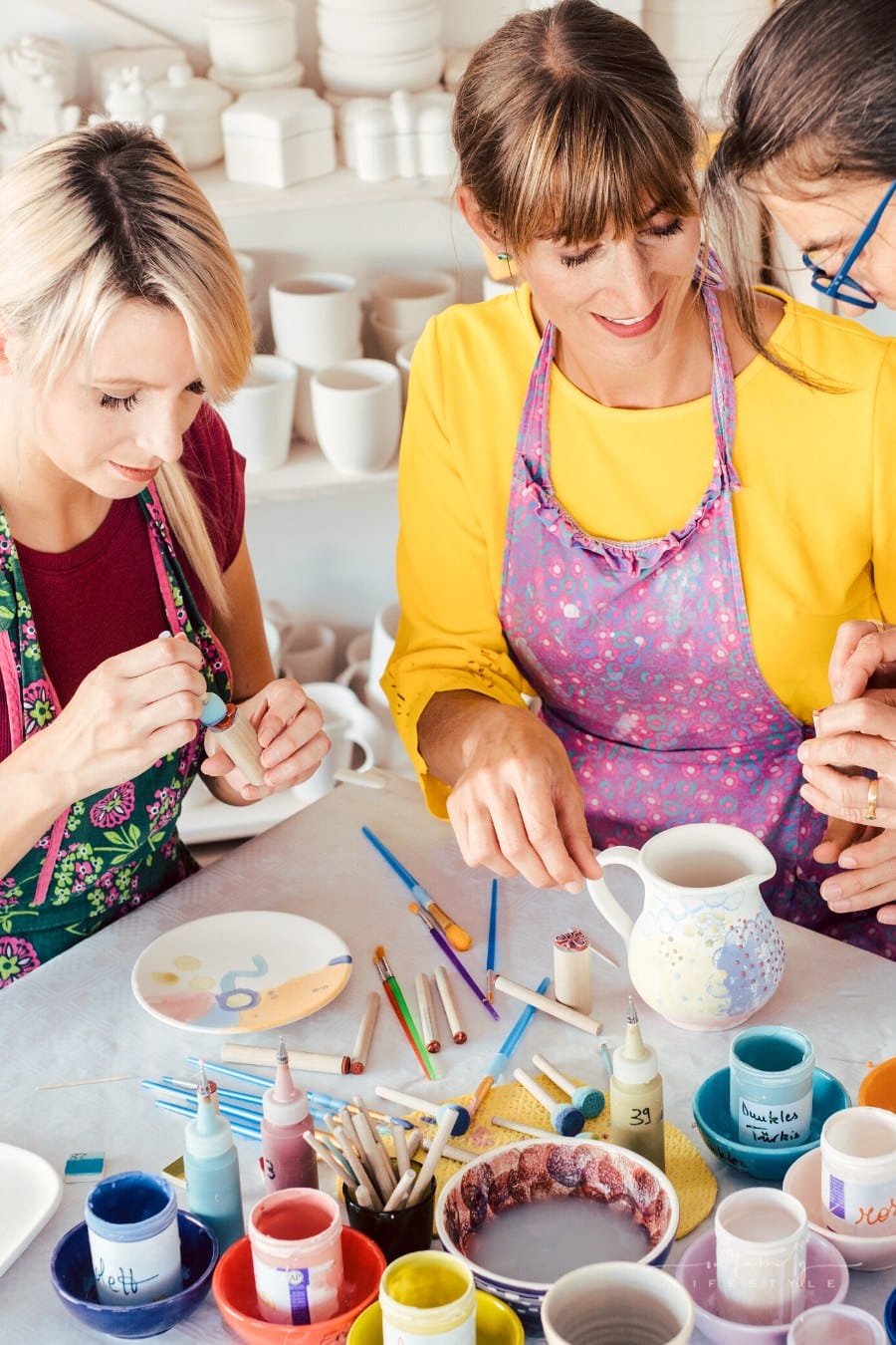 women taking a ceramic painting class