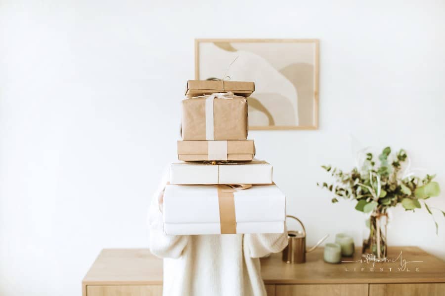 Person Holding Stack of Large Gift Boxes